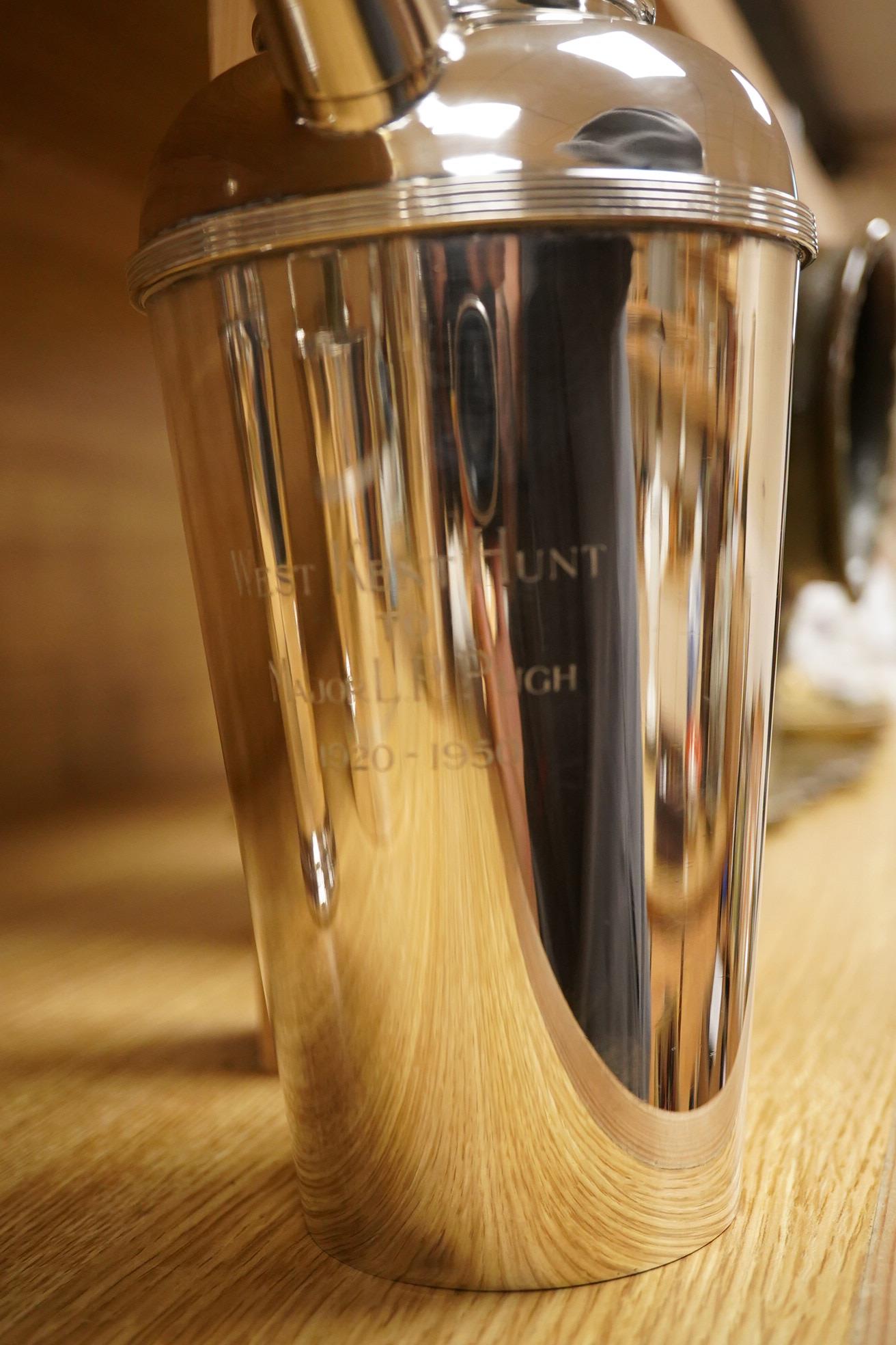 A mid 20th century silver plated patent cocktail shaker with recipes, two other cocktail shakers and an ice bucket, largest 28cm high